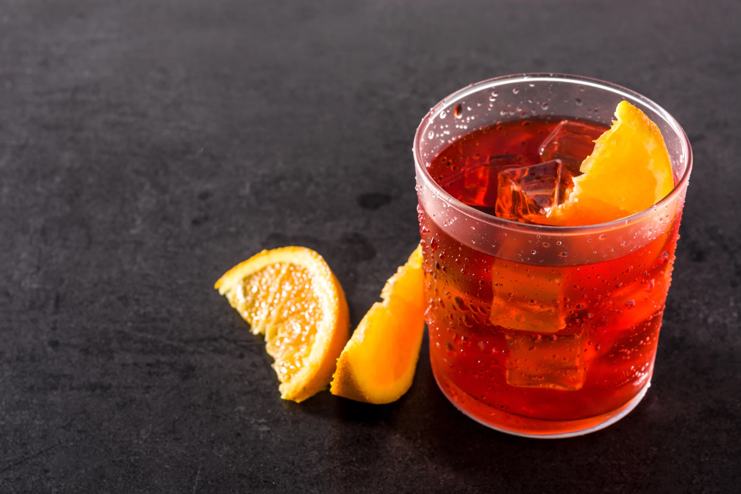 Negroni cocktail with piece orange glass