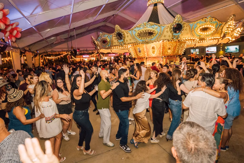People dancing in conga line at Carousel Club